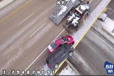 Driver crawls from SUV teetering on Milwaukee bridge after crash