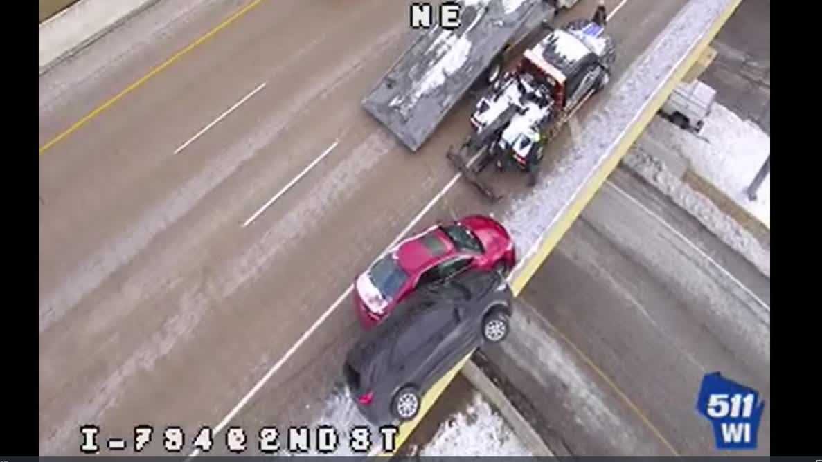Driver crawls from SUV teetering on Milwaukee bridge after crash